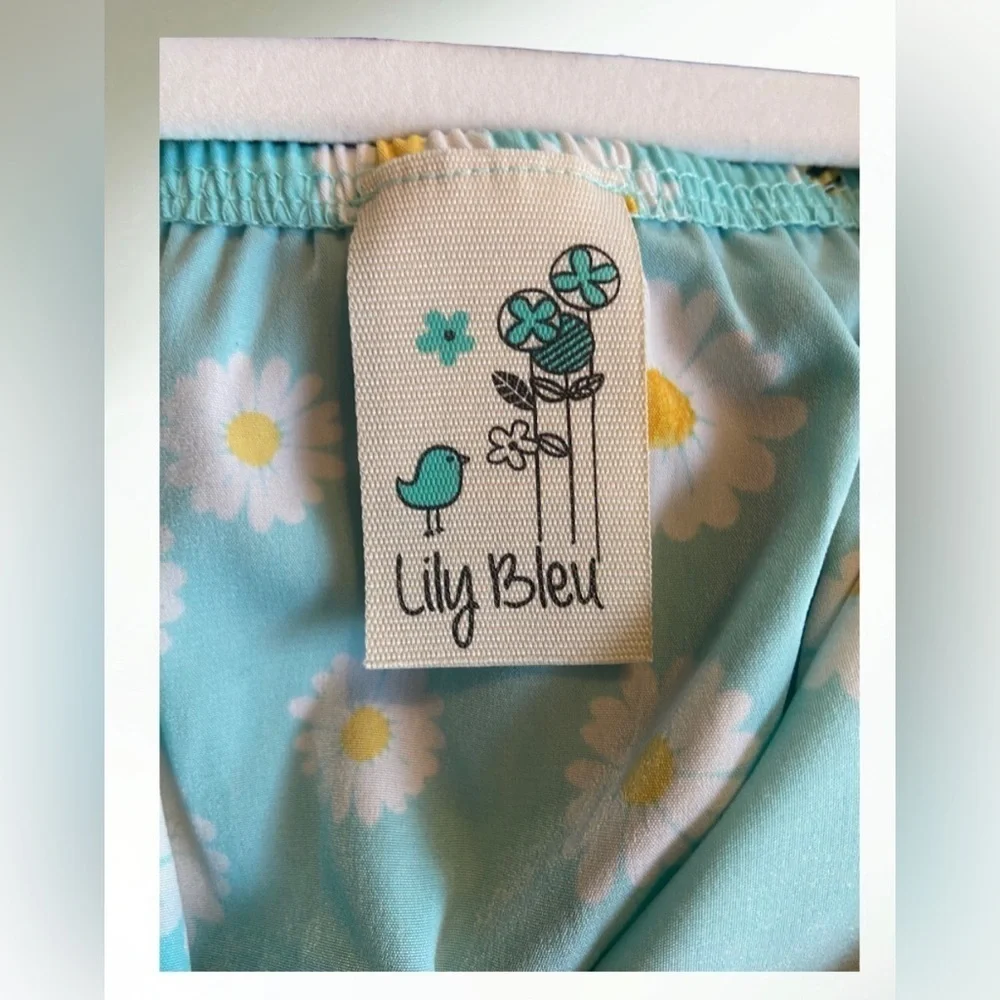 Lily Bleu Short romper in light blue aqua with white flowers and tie front.